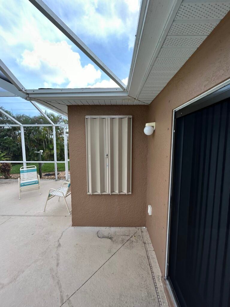 House windows with metal storm shutters.