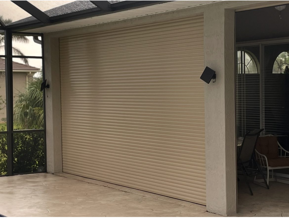 Closed beige roller garage door at a residential home.